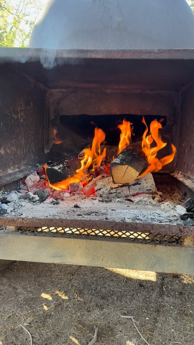 Close-up of flames inside the wood-fired smoker
