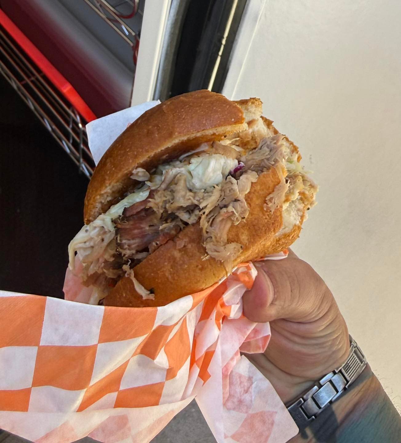 Pulled pork and coleslaw sandwich on a brioche bun