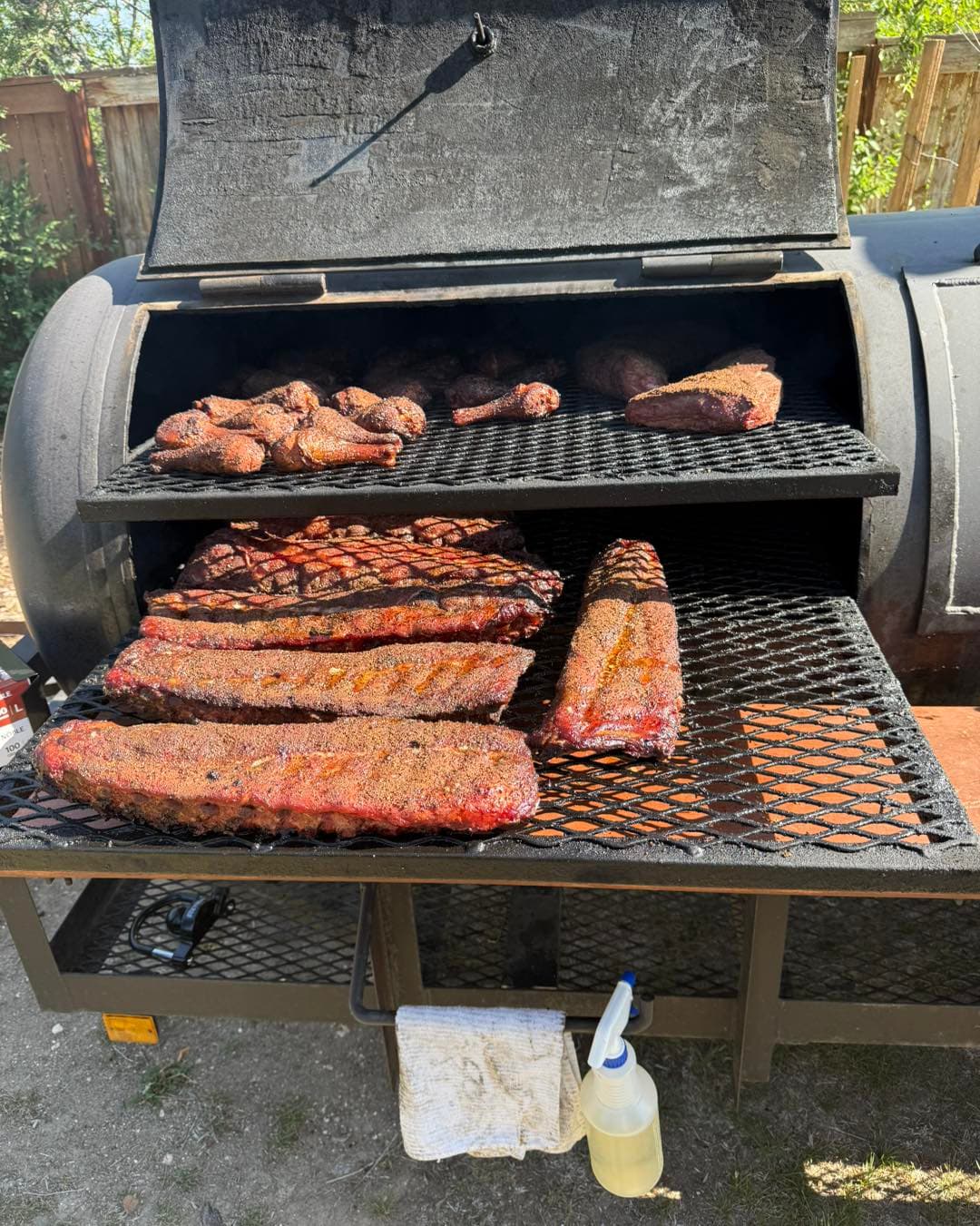 Ribs, brisket, and chicken smoking on the offset smoker